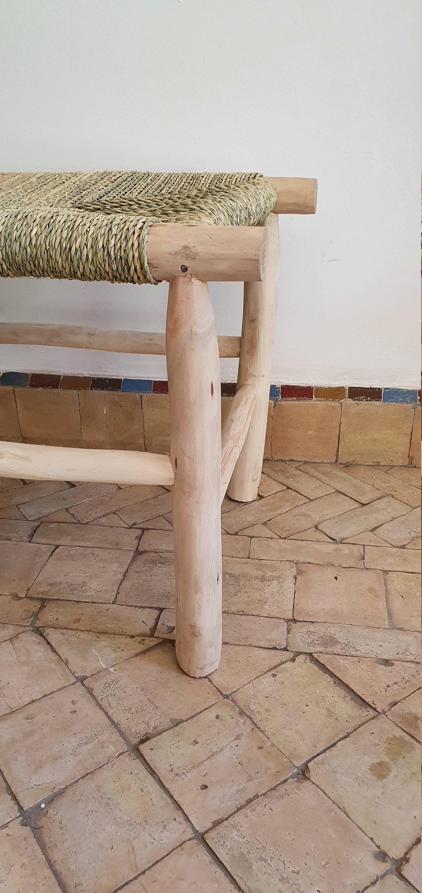 Handmade Moroccan bench featuring woven solid wood construction