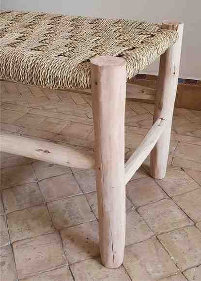 Moroccan-inspired wooden bench with handwoven details, exuding elegance