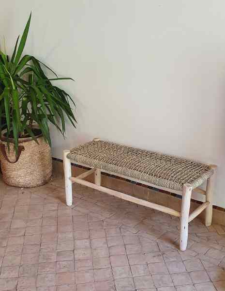 Handcrafted wooden bench featuring natural weaving, perfect for both indoor and outdoor spaces