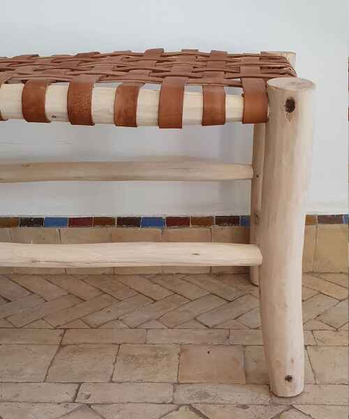 Premium quality Moroccan bench showcasing intricate woodwork and rich camel leather