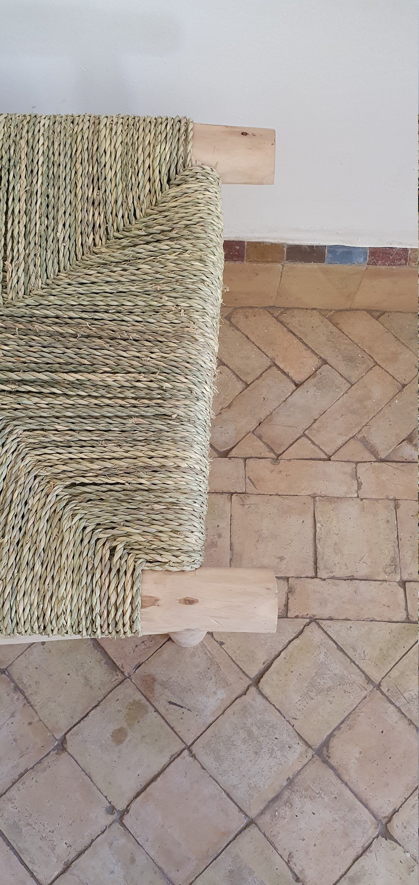 A woven wooden bench with Moroccan-inspired design